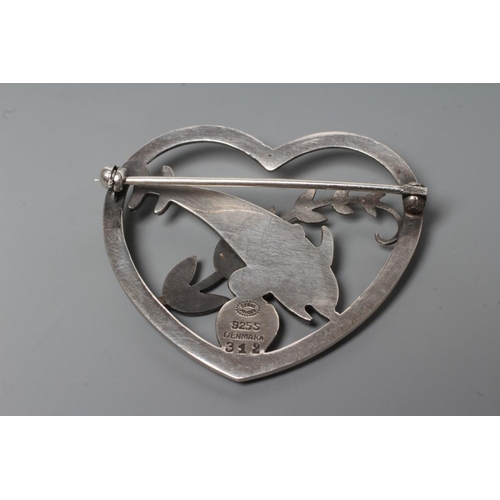 183 - A GEORG JENSEN SILVER HEART BROOCH designed by Arno Malinowski, cast as two dolphins swimming amidst... 