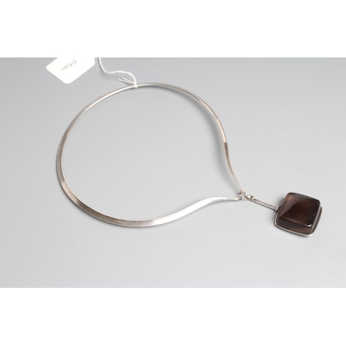 187 - A GEORG JENSEN SILVER NECK RING designed by Vivianna Torun Bulow-Hube with tension clamp and hung wi... 