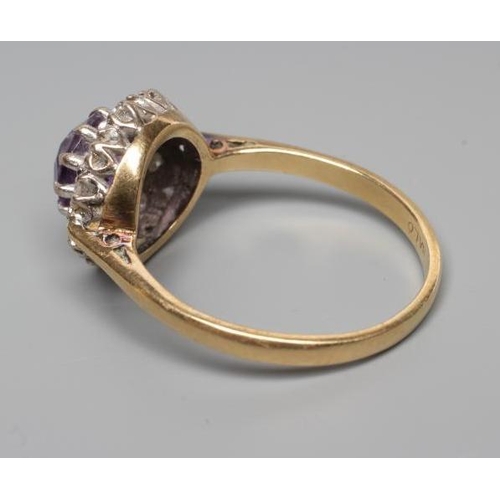 190 - AN AMETHYST AND DIAMOND CLUSTER RING, the circular facet cut amethyst claw set to a border illusion ... 