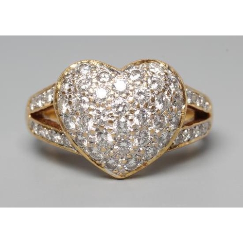 192 - A DIAMOND DRESS RING, the heart shaped panel point set with numerous small stones to open diamond se... 