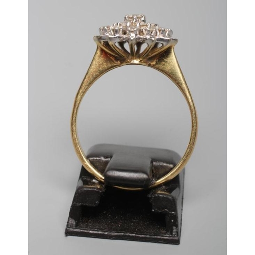 196 - A DIAMOND CLUSTER RING, the central seven stone cluster to a border of twelve smaller stones and pla... 