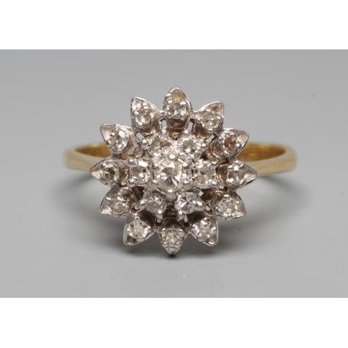 196 - A DIAMOND CLUSTER RING, the central seven stone cluster to a border of twelve smaller stones and pla... 