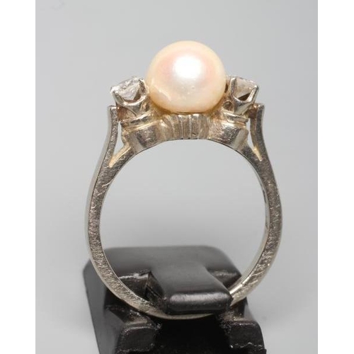 217 - A THREE STONE PEARL AND DIAMOND DRESS RING, the cultured pearl of approximately fourteen metric grai... 