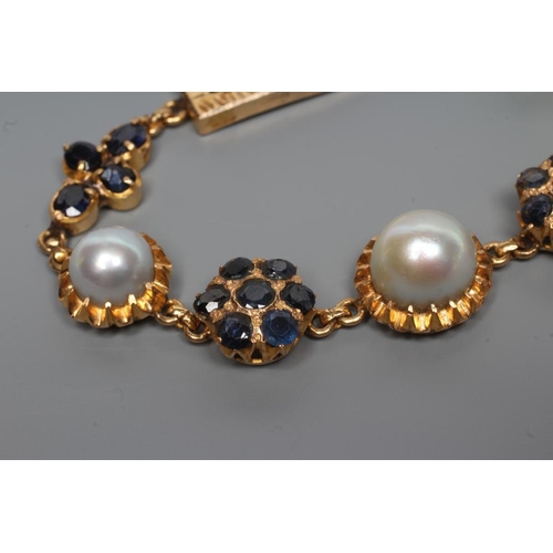 219 - A SAPPHIRE AND PEARL BRACELET, the three graduated grey pearls set in frilled mounts between a pair ... 