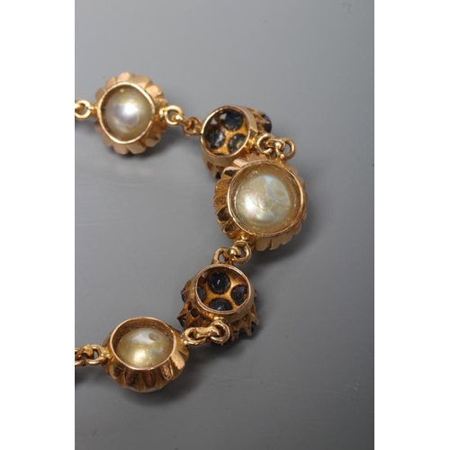 219 - A SAPPHIRE AND PEARL BRACELET, the three graduated grey pearls set in frilled mounts between a pair ... 