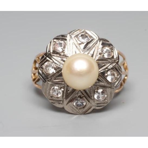 229 - A PEARL AND DIAMOND COCKTAIL RING, the peg set cultured pearl within a white metal petal border set ... 