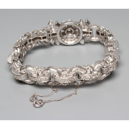 241 - A DIAMOND BRACELET, the central cluster with bow shoulders and open circular links and invisible hin... 