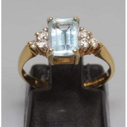 248 - AN AQUAMARINE AND DIAMOND RING, the oblong facet cut aquamarine claw set between shoulders each set ... 