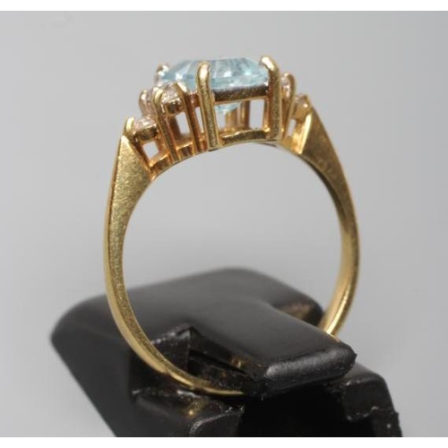 248 - AN AQUAMARINE AND DIAMOND RING, the oblong facet cut aquamarine claw set between shoulders each set ... 