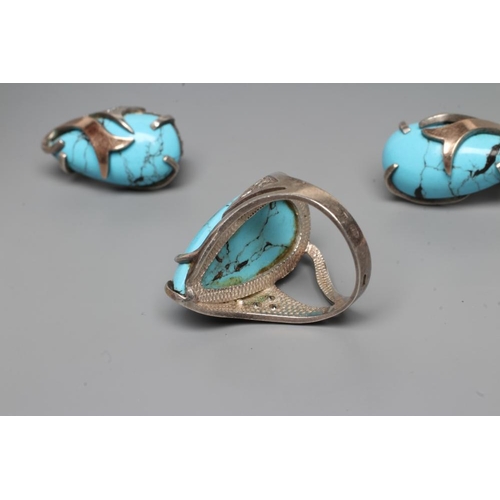 249 - A TURQUOISE MATRIX RING, the tear polished stone asymmetrically set in unmarked white metal with thr... 