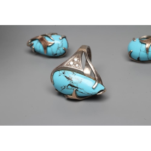 249 - A TURQUOISE MATRIX RING, the tear polished stone asymmetrically set in unmarked white metal with thr... 