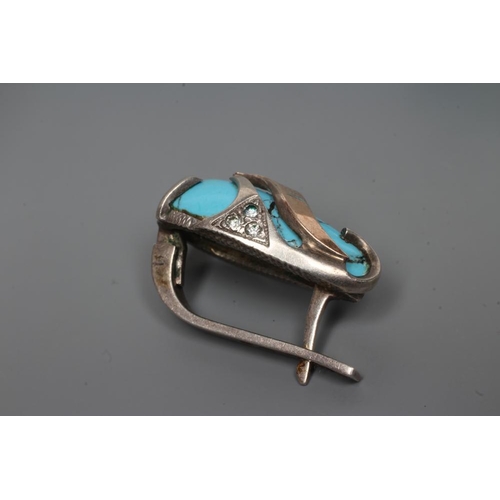 249 - A TURQUOISE MATRIX RING, the tear polished stone asymmetrically set in unmarked white metal with thr... 