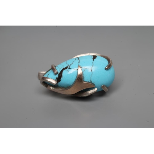 249 - A TURQUOISE MATRIX RING, the tear polished stone asymmetrically set in unmarked white metal with thr... 