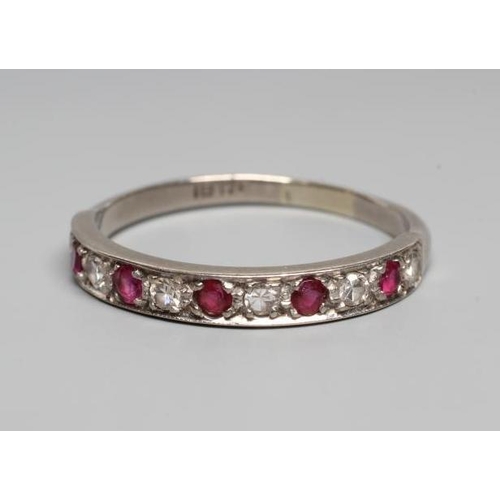 255 - A RUBY AND DIAMOND HALF HOOP RING, the five rubies and six diamonds point set to a plain white shank... 