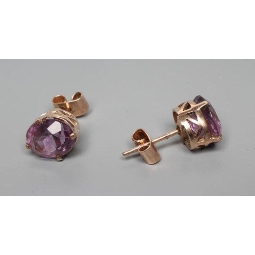 257 - A PAIR OF AMETHYST EAR STUDS, the oval facet cut stones claw set to a plain unmarked frame (Est. plu... 