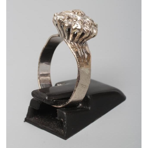 259 - A DIAMOND CLUSTER RING, the mix cut stones claw set to a later white unmarked shank, size L (Est. pl... 