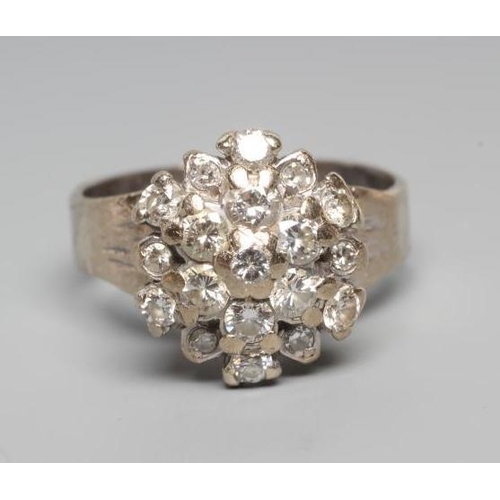 259 - A DIAMOND CLUSTER RING, the mix cut stones claw set to a later white unmarked shank, size L (Est. pl... 