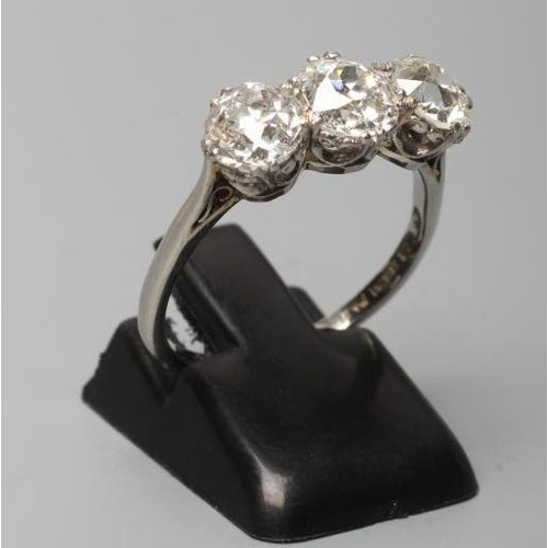 178 - A THREE STONE DIAMOND RING, the brilliant cut stones totalling approximately 2.75cts, claw set to a ... 