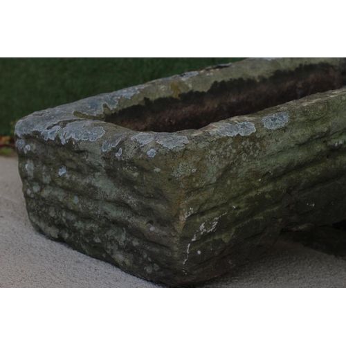 470 - A SANDSTONE TROUGH of rough hewn oblong form, 27 1/2