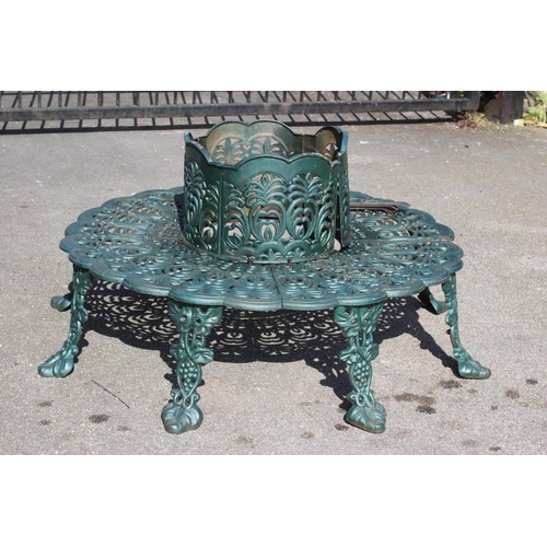 471 - A CAST IRON TREE SEAT, modern, comprising two sections pierced with foliage, the raised back with wa... 