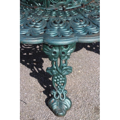 471 - A CAST IRON TREE SEAT, modern, comprising two sections pierced with foliage, the raised back with wa... 