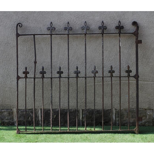 484 - A VICTORIAN CAST IRON GARDEN GATE of two tier barred form with fleur de lys finials and scroll heade... 