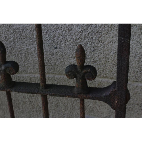 484 - A VICTORIAN CAST IRON GARDEN GATE of two tier barred form with fleur de lys finials and scroll heade... 