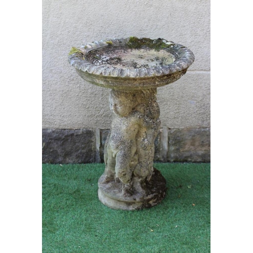 525 - A HADDONSTONE BIRD BATH, the moulded circular bowl with ovolu rim held aloft by three putti, on moul... 