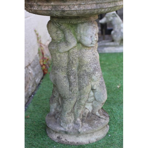 525 - A HADDONSTONE BIRD BATH, the moulded circular bowl with ovolu rim held aloft by three putti, on moul... 