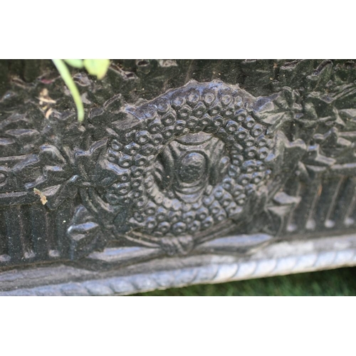 528 - A PAIR OF CAST IRON JARDINIERES of oblong tapering form with flared rim on foliate bracket feet, the... 