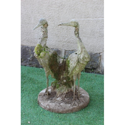 549 - A CAST IRON FOUNTAIN, modelled as a pair of herons amongst foliage issuing a water spout, on circula... 