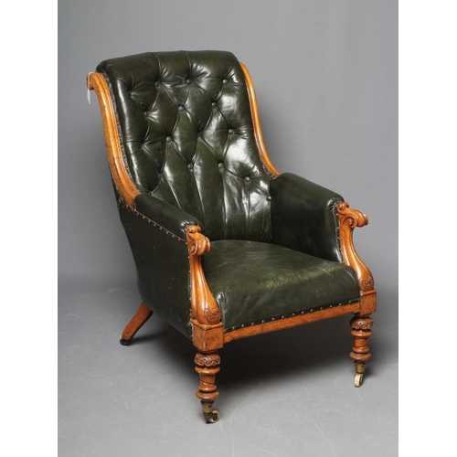 659 - AN MID VICTORIAN OAK FRAMED ARMCHAIR button upholstered in green leather, channelled scroll back upr... 