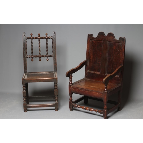 672 - A JOINED OAK ARMCHAIR, early 18th century, the twin panelled back with waved top rail, shaped downsw... 