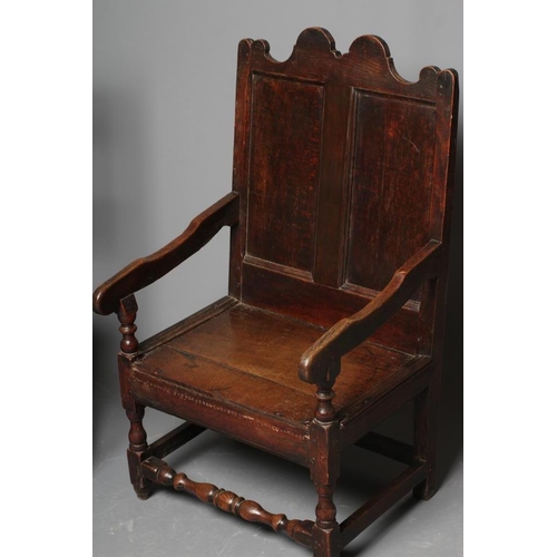 672 - A JOINED OAK ARMCHAIR, early 18th century, the twin panelled back with waved top rail, shaped downsw... 