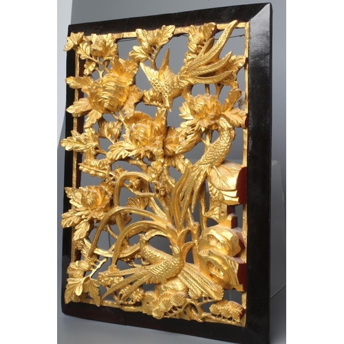 313 - A CHINESE GILT WOOD AND BLACK LACQUERED PANEL, c.1900, the centre pierced and carved in high relief ... 