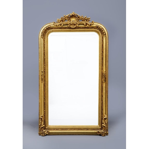 647 - A VICTORIAN STYLE GILT GESSO PIER GLASS, the mildly arched bevelled plate within a cushion moulded f... 