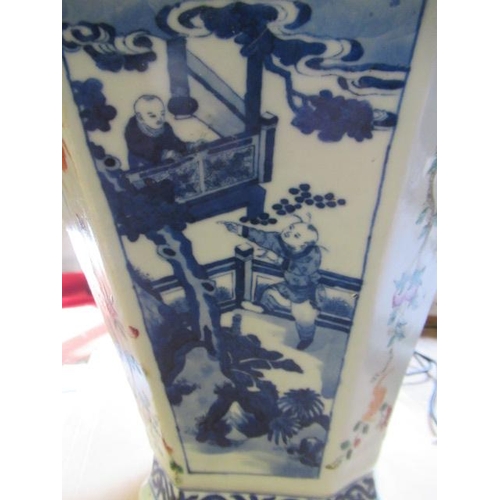 12 - A CHINESE PORCELAIN VASE of swept octagonal form with two scrolling handles, painted in in underglaz... 