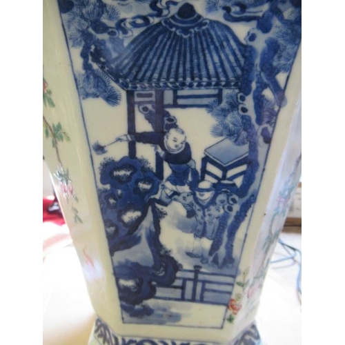 12 - A CHINESE PORCELAIN VASE of swept octagonal form with two scrolling handles, painted in in underglaz... 