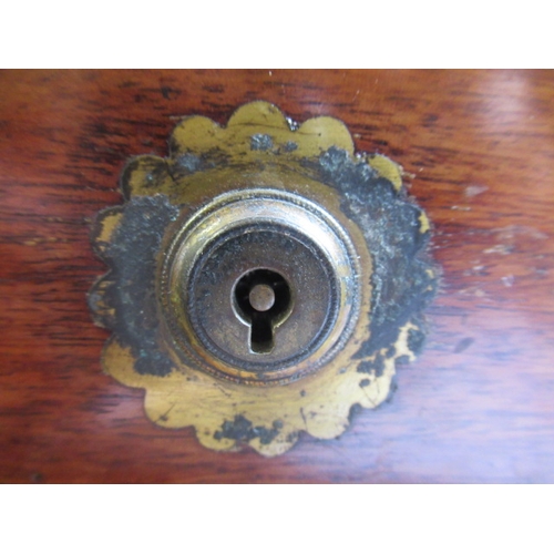 296 - A VICTORIAN MAHOGANY AND BRASS BOUND LAP DESK, the lid inset with brass shield inscribed 