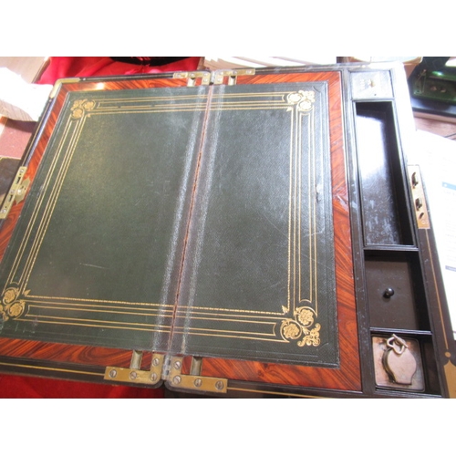 296 - A VICTORIAN MAHOGANY AND BRASS BOUND LAP DESK, the lid inset with brass shield inscribed 