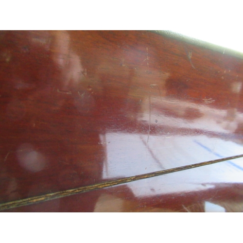 296 - A VICTORIAN MAHOGANY AND BRASS BOUND LAP DESK, the lid inset with brass shield inscribed 