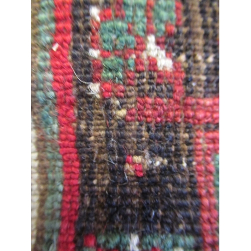 329 - A TURKISH PRAYER RUG, the green field with stepped red niche with flowers and candles, within a mult... 