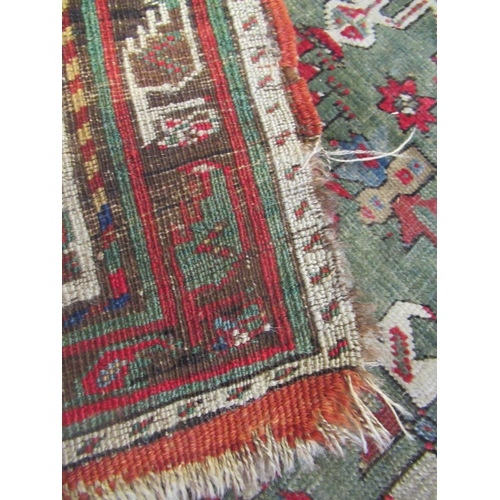 329 - A TURKISH PRAYER RUG, the green field with stepped red niche with flowers and candles, within a mult... 