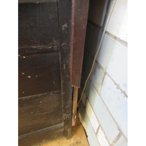 662 - AN OAK CLOTHES PRESS, c.1700, the moulded edged plank top over a pair of twin panel doors enclosing ... 