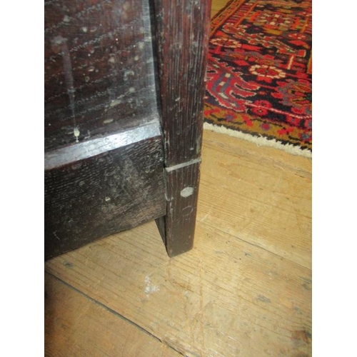 662 - AN OAK CLOTHES PRESS, c.1700, the moulded edged plank top over a pair of twin panel doors enclosing ... 