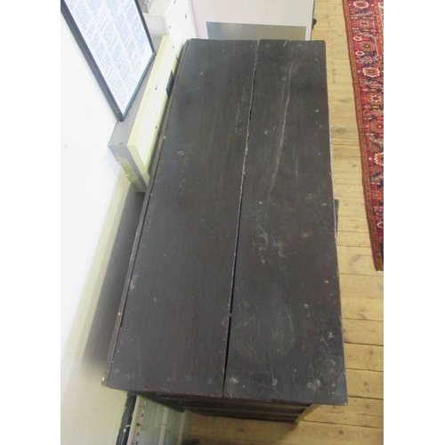 662 - AN OAK CLOTHES PRESS, c.1700, the moulded edged plank top over a pair of twin panel doors enclosing ... 