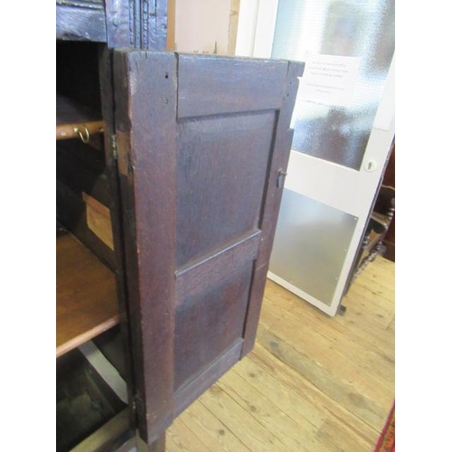 662 - AN OAK CLOTHES PRESS, c.1700, the moulded edged plank top over a pair of twin panel doors enclosing ... 