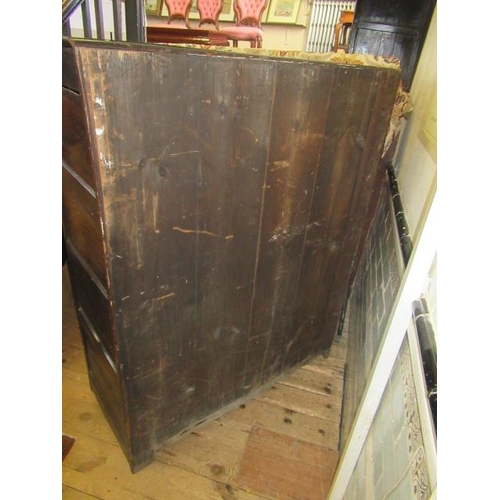 662 - AN OAK CLOTHES PRESS, c.1700, the moulded edged plank top over a pair of twin panel doors enclosing ... 