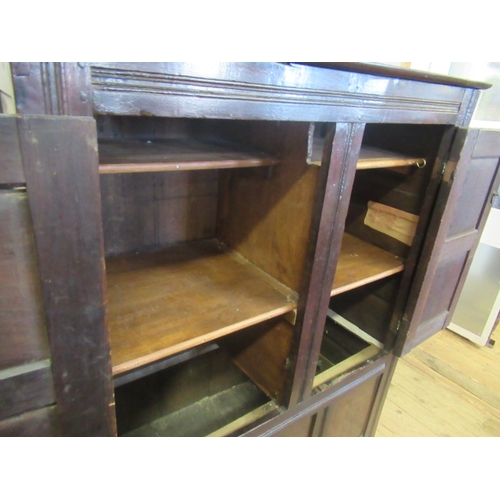 662 - AN OAK CLOTHES PRESS, c.1700, the moulded edged plank top over a pair of twin panel doors enclosing ... 