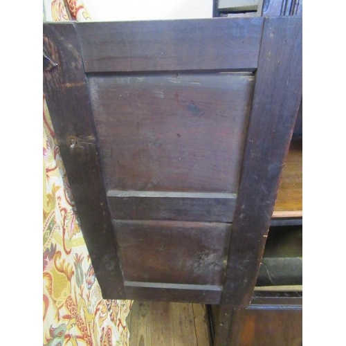 662 - AN OAK CLOTHES PRESS, c.1700, the moulded edged plank top over a pair of twin panel doors enclosing ... 